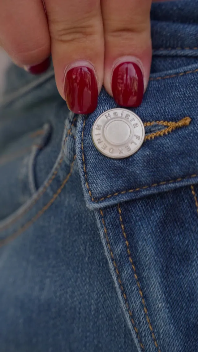 Denim close-up from the Halara reel: jeans button and red manicure