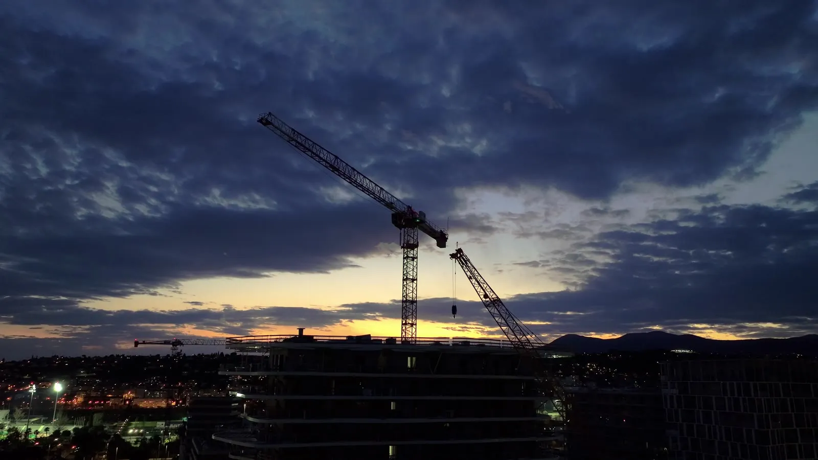 Silhouette of the Hana building tower crane at dusk, before the night-time dismantling operation